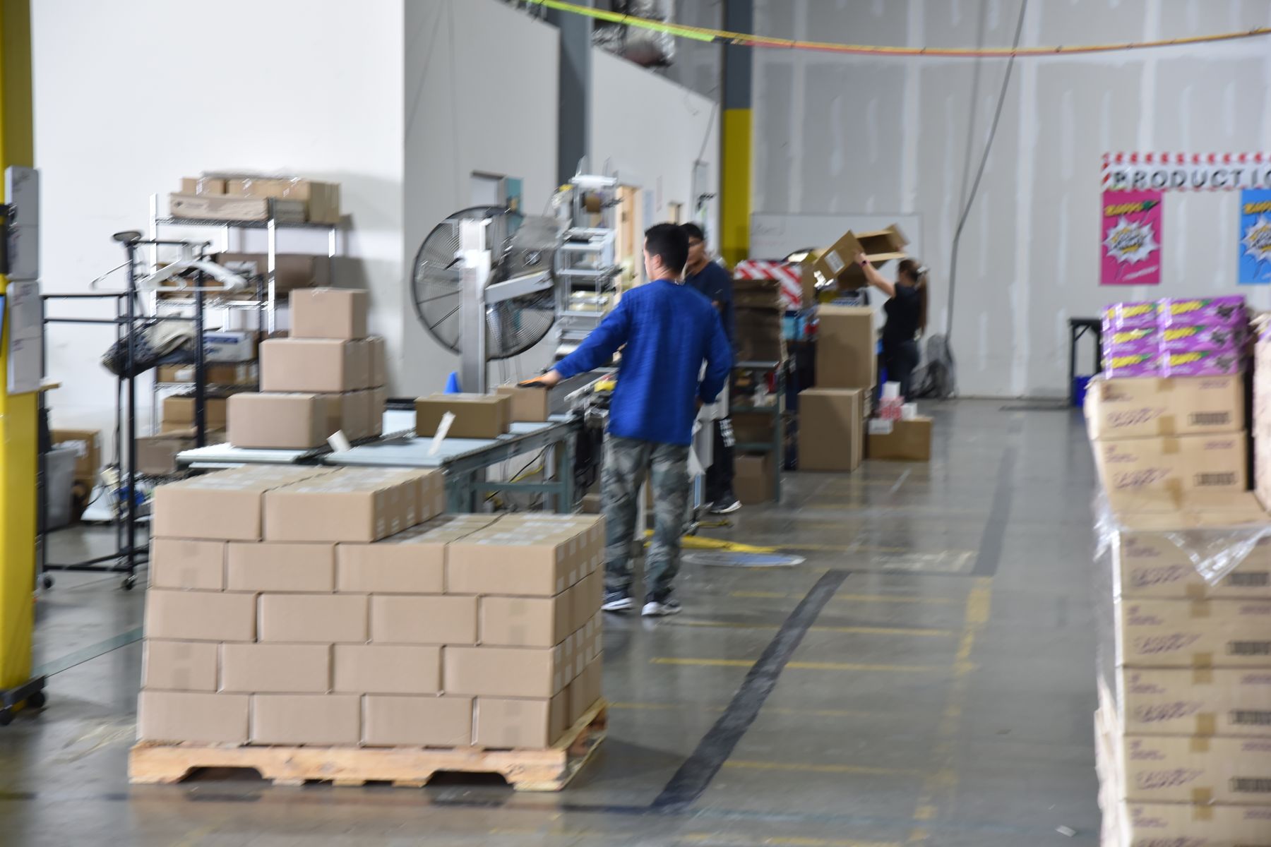 Team member building a pallet of cases for a retail order