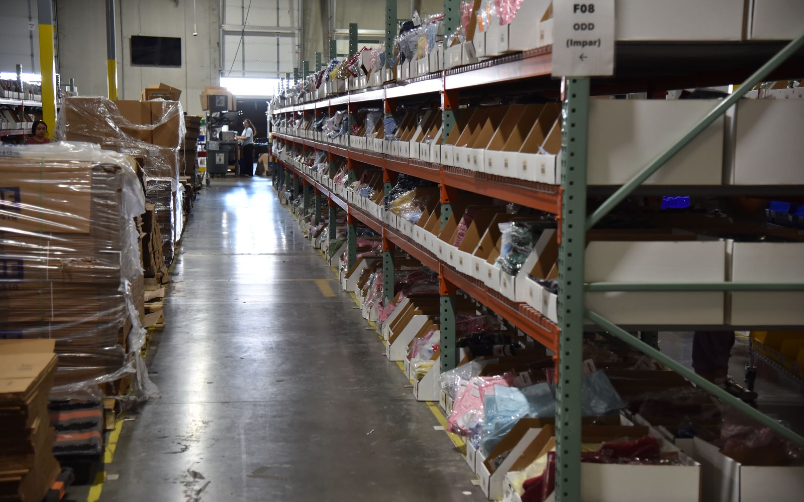 Pick aisle of shelving with labeled bins of ecommerce inventory