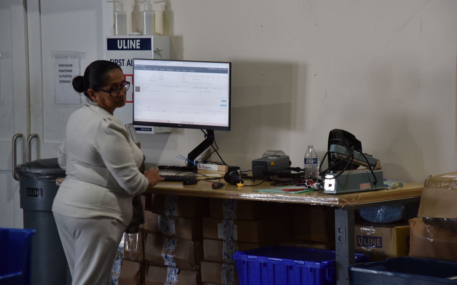 Team member working in the warehouse management system at a desk
