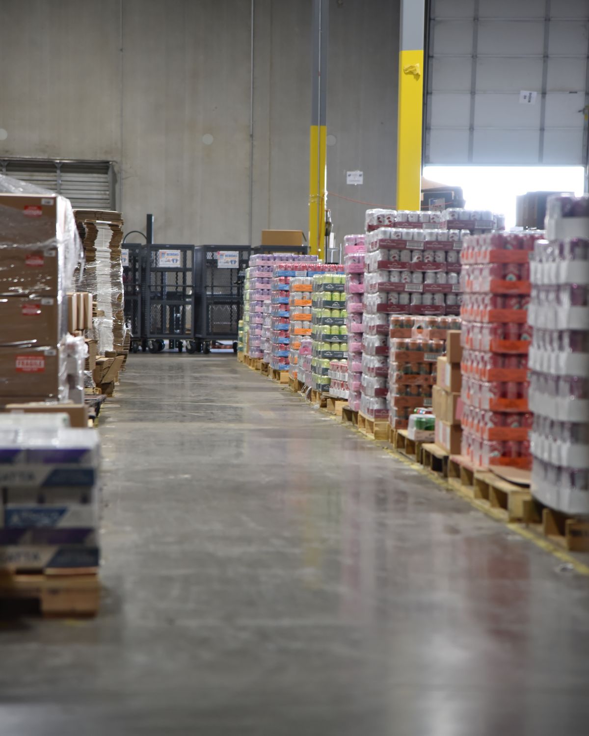 Food and beverage pallets staged in a warehouse aisle