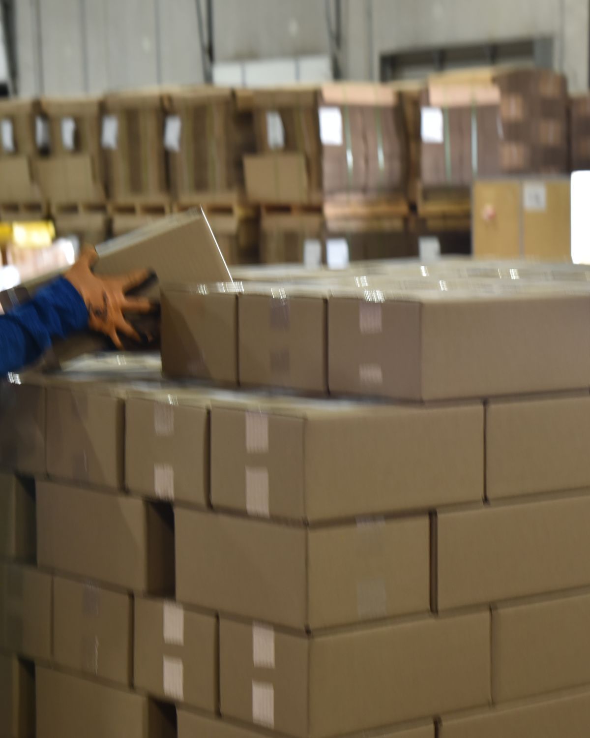 Team member stacking cases onto a pallet for a retail shipment